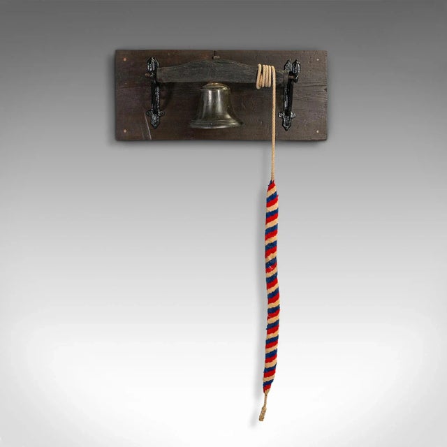 This is an antique mounted school bell. An English, bronze bell on oak and pine plinth, dating to the Georgian period,...