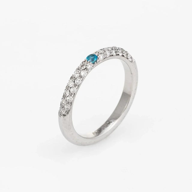 Elegant Adolfo Courrier stacking ring, crafted in 18 karat white gold. One estimated 0.05 carat turquoise, accented with...