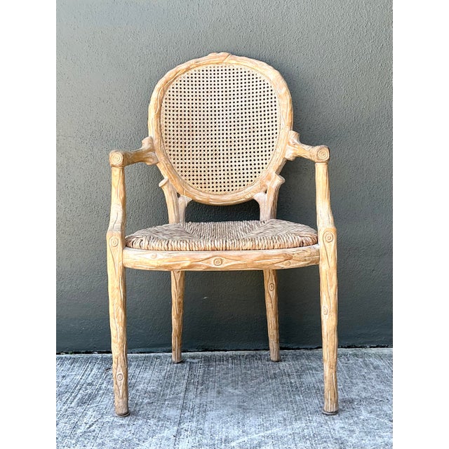 This exceptional vintage armchair is a masterclass in the "faux bois" tradition, expertly crafted to mimic the organic...