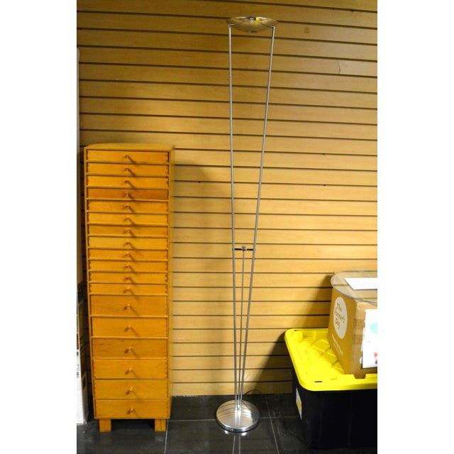 The Estiluz Chrome Torchière Floor Lamp by Leonardo Marelli is a sleek, post-modern architectural piece designed for both...