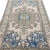 This beautiful vintage rug features a bold and highly stylized central medallion set against an ivory ground. The...