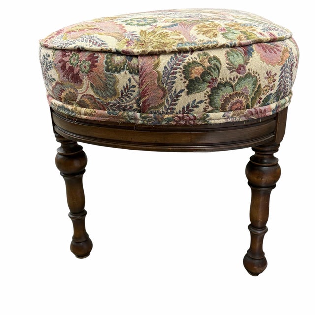 Antique upholstered long bench or ottoman in tapestry floral print sitting on a dark brown frame. Colors include pink,...