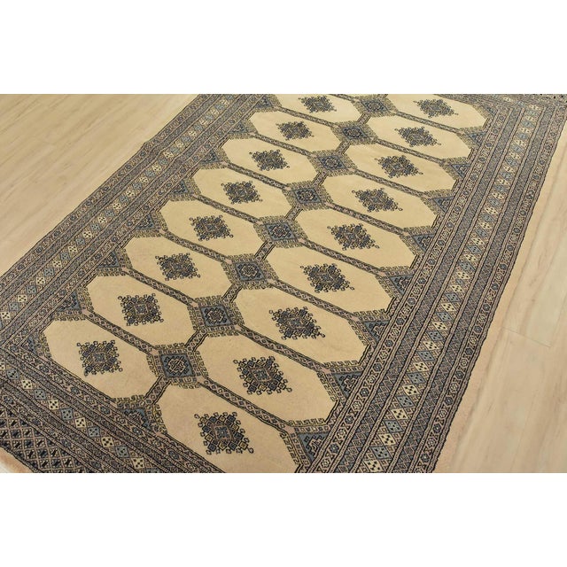 A tribal Bokhara Jaldar rug hand-knotted with fine wool on a cotton foundation. This rug features rows of repeating...