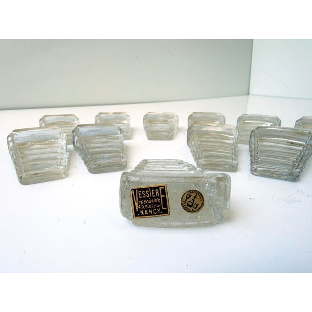 An exceptional set of twelve Baccarat crystal cale-assiettes (plate tilters), sourced in Paris. Designed to gently incline...
