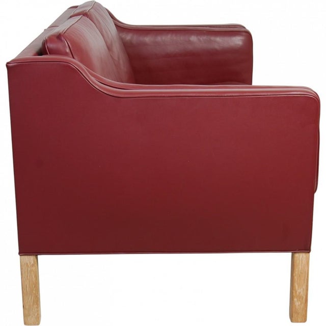 Børge Mogensen 2212 2.seater sofa upholstered in original red wine colored leather, with legs of oak. The sofa is from the...