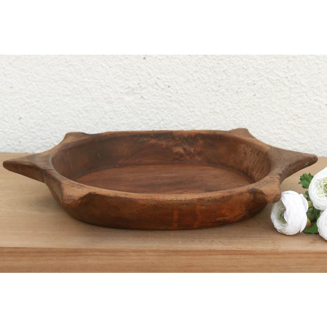 The sculptural form of this vintage bowl takes center stage. Carved from a single piece of solid hardwood, it features a...