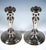 A pair of baluster-shaped candlesticks on a round, slightly stepped base, featuring an engraved band of waves running all...