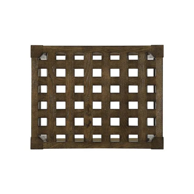 A curved, pierced lattice work seat is raised by splayed, tapering legs that are joined by a box stretcher.