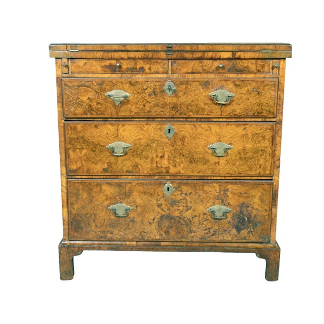 With rectangular quarter veneered hinged top that flips forward to form a writing surface over two small valuables drawers...