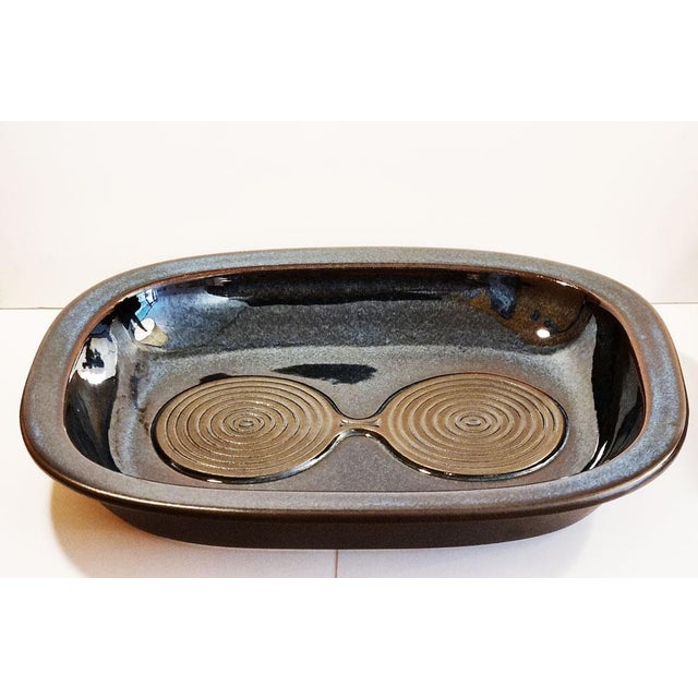 Important deep blue enamelled stoneware dish with raised edges and decoration of black spirals Design by Einar Johansen...