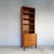 A tall, narrow domi monté bookcase in two parts: an open shelving unit sits on a four-drawer chest. Because it's slim, you...