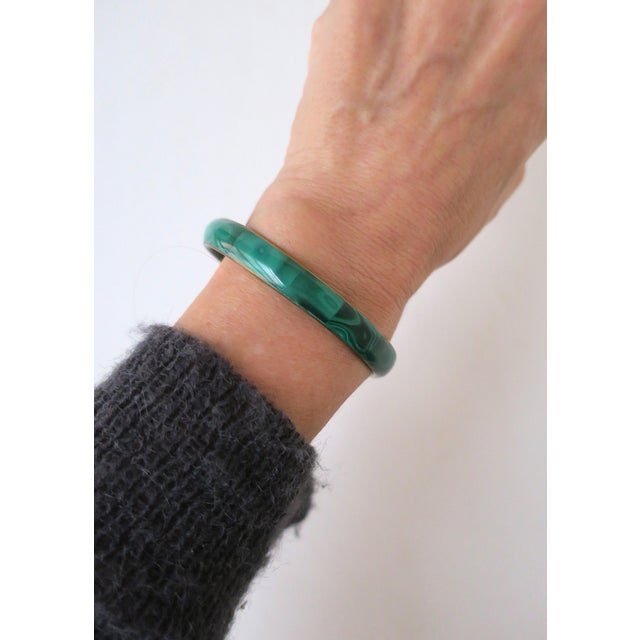 A beautiful green Malachite and brass bangle bracelet, circa late-20th century. Wear alone for stack with other bracelets....