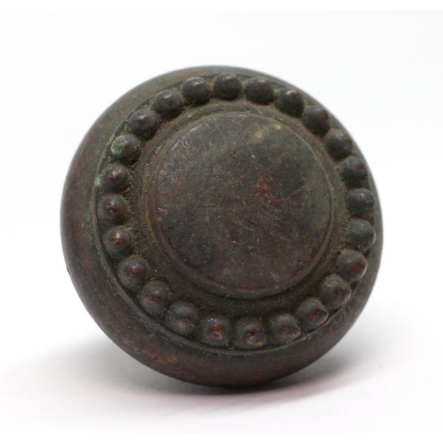 Concentric beaded bronze knob with a dark patina. The manufacturer and date of creation is unknown. It is part of the...