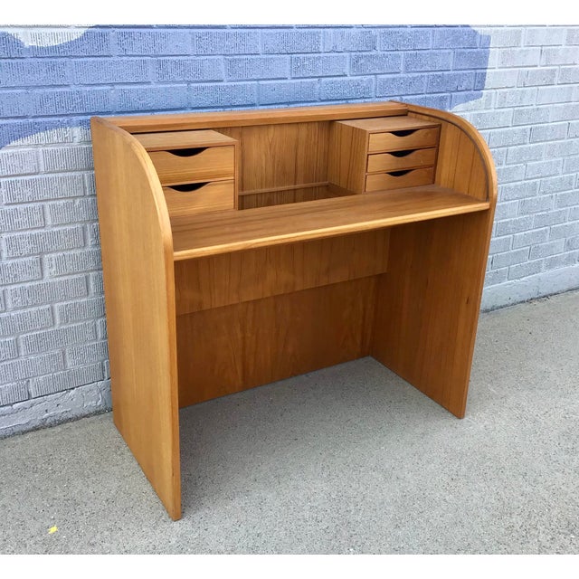This Danish Modern Mid-Century Teak Rolltop Desk is perfectly compact yet contains an abundance of storage. Stamped "Made...