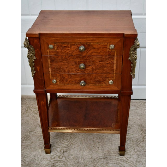 Vintage (1980s) Accent Chest has an Italian Regency Style. Made of Wood. Inlaid Exotic Woods. The Chest has Three Drawers,...