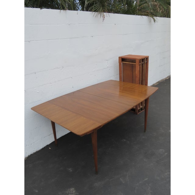 This Dining Table is made out of wood, solid wood, walnut, and veneer. The Table has Mid Century style and design, it has...