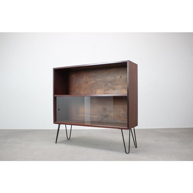 Refined Danish mid-century cabinet from the 1960s showcasing clean Scandinavian modern lines and practical functionality....