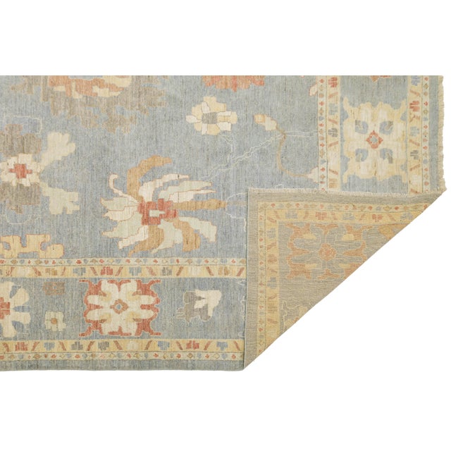 Elevate your living space with this exquisite hand-knotted wool rug, masterfully crafted in the timeless Oushak style....