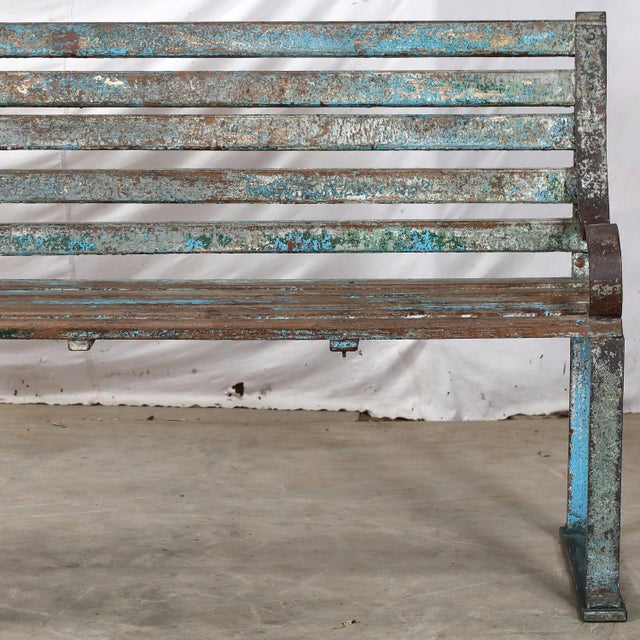 Vintage Indian Painted Teakwood and Iron Bench, a charming garden bench retaining some of its old blue paint finish. This...
