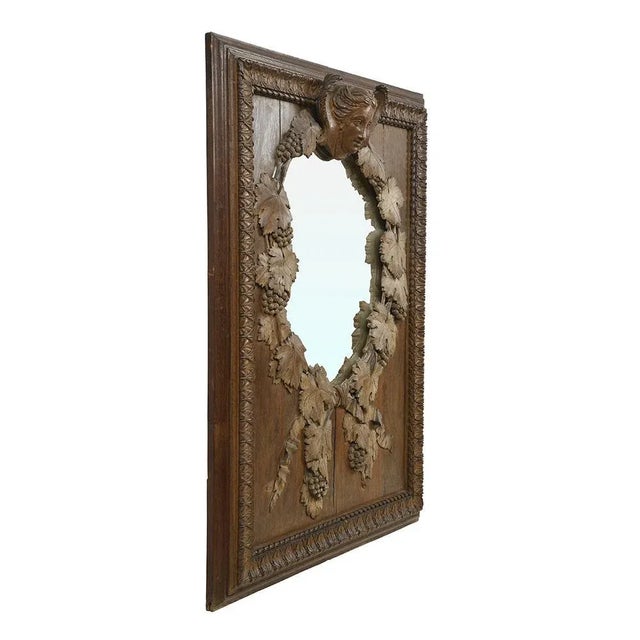 Mercury mirror of the 19th century in carved wood. This piece is designed in the style of the selected designer and/or...