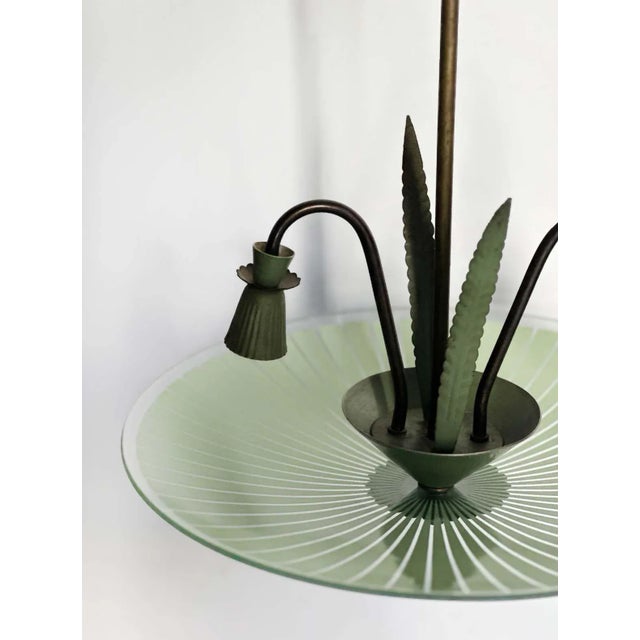 Vintage Murano glass and metal pendant made in Italy, c. 1960's by Stilnovo. This fixture stands out due to its beautiful...