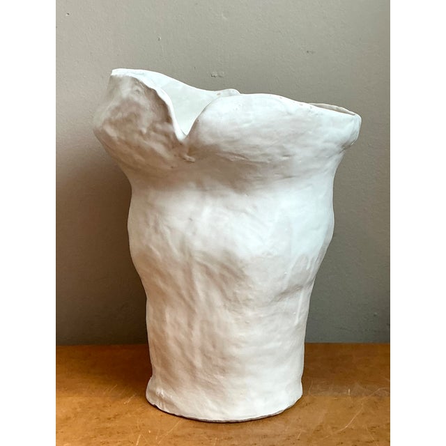 This biomorphic sculptural white ceramic vase combines the presence of a small sculpture with the function of a decorative...