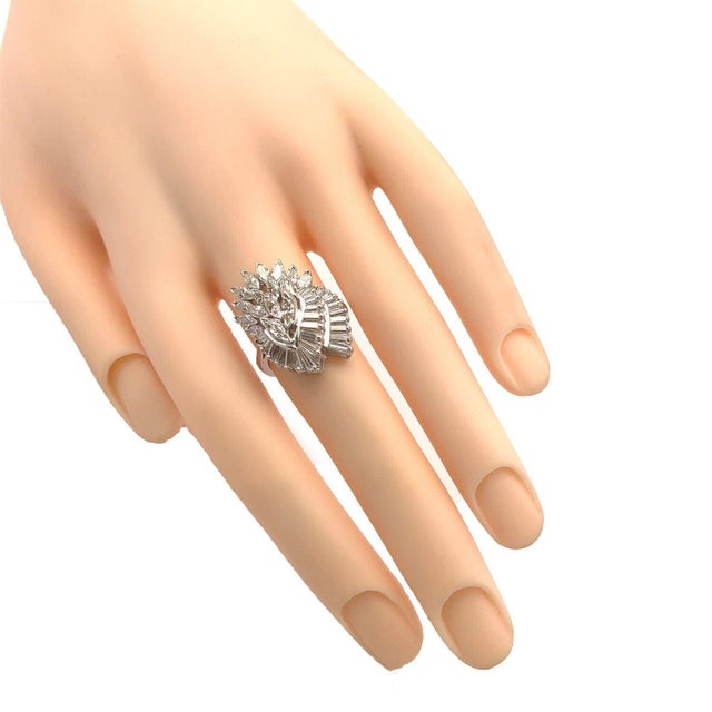 This gorgeous cocktail ring is crafted from 14k white gold with a polished finish. The top has a lovely cascade design...