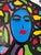 A striking, colorful portrait signed Pulgini, rendered in bold modernist strokes and jewel-toned blocks of color against a...