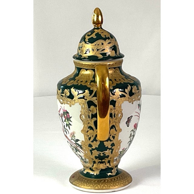 Expertly decorated porcelain urn with a lid and finial,from the 19th or early 20th century Hand painted designs with...