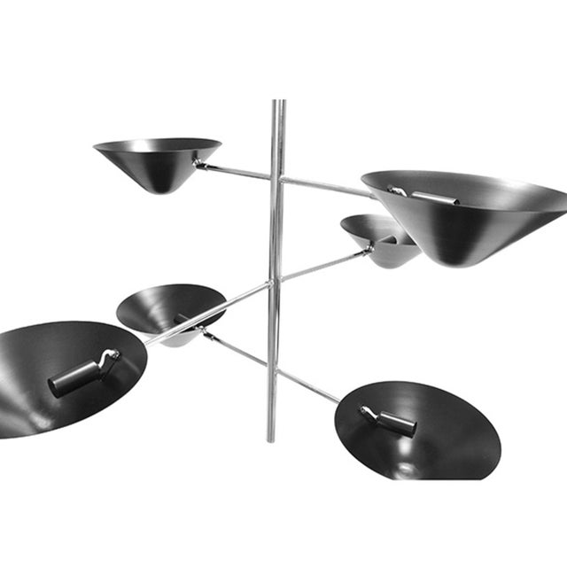 Three crossed, polished nickel arms balance six matte black uplight shades in air like a tightrope artist and ensure this...