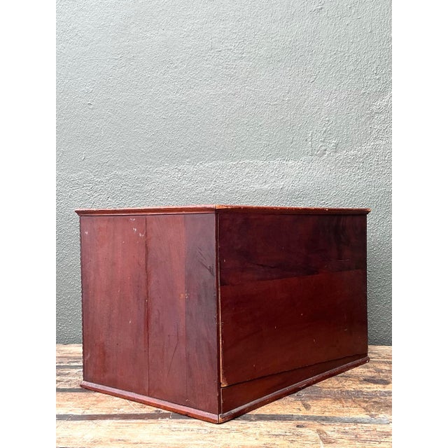 This elegant vintage tabletop chest of drawers is a masterful blend of traditional charm and practical storage. Defined by...
