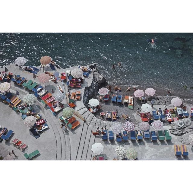 Positano Beach 1979 Elevated view looking down on sunbathers and parasols on the beach at La Scogliera beach in Positano,...