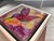 This artwork features a vibrant hummingbird, captured in mid-flight with expressive strokes that emphasize its dynamic...