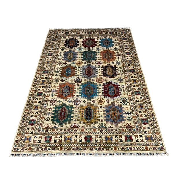 Bring color and intricate pattern to your home with this Afghan Sultani natural-dye wool area rug. An ivory and beige...