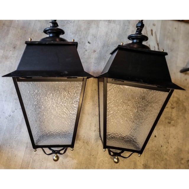 Street lanterns mounted on wrought iron scrolled brackets. Brass balls and bobeches. PVC tray for glassware. Completely...