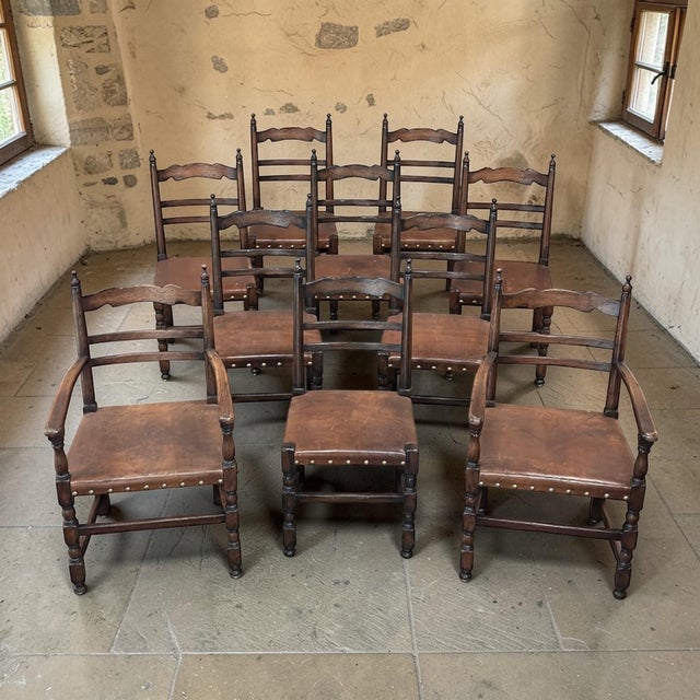 Country French warmth and enduring craftsmanship define this substantial set of ten dining chairs, executed in solid oak...