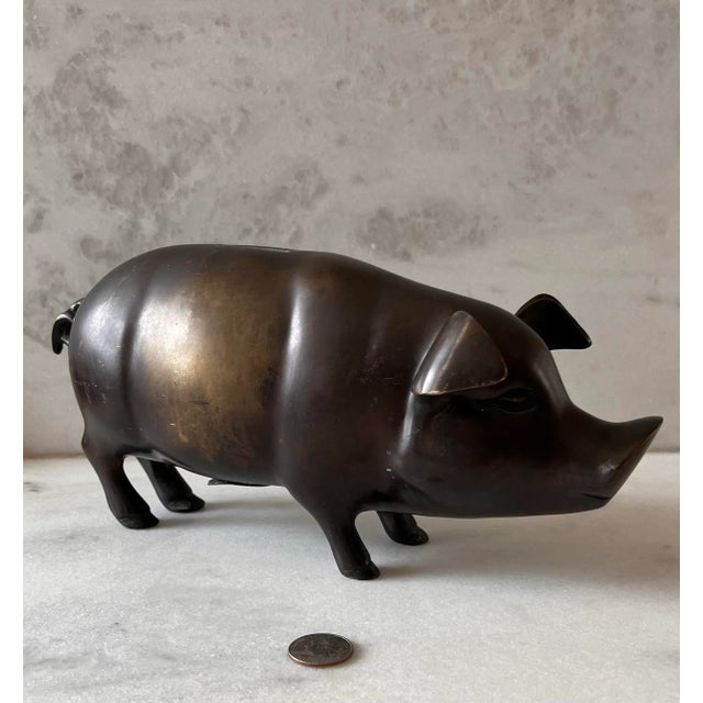 Large vintage late 20th century bronze piggy bank with rubber stopper on the underside of pig.