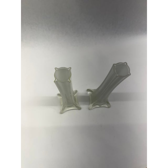 Sleek and sculptural pair of vintage mid-century modern bud vases featuring crisp opaque white interiors cased in clear...