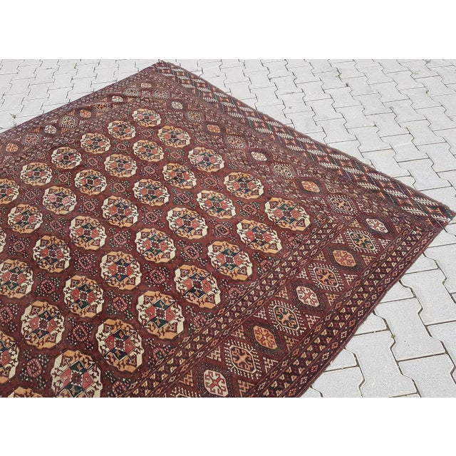 This is a vintage low pile Turkmen rug from the 1950s. The piece was handwoven with high quality pure wool and cotton. Low...