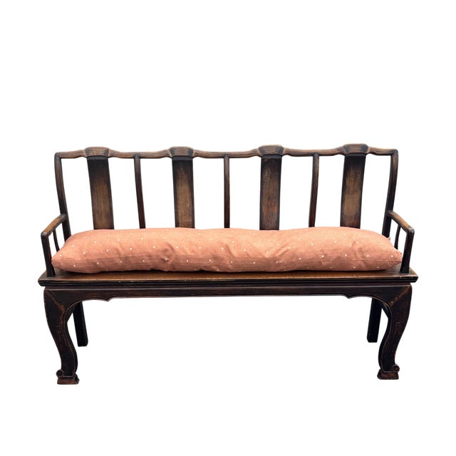 Four-seater long bench with custom upholstered pillow in a salmon colored linen with metallic dot embroidery, velcro loop...