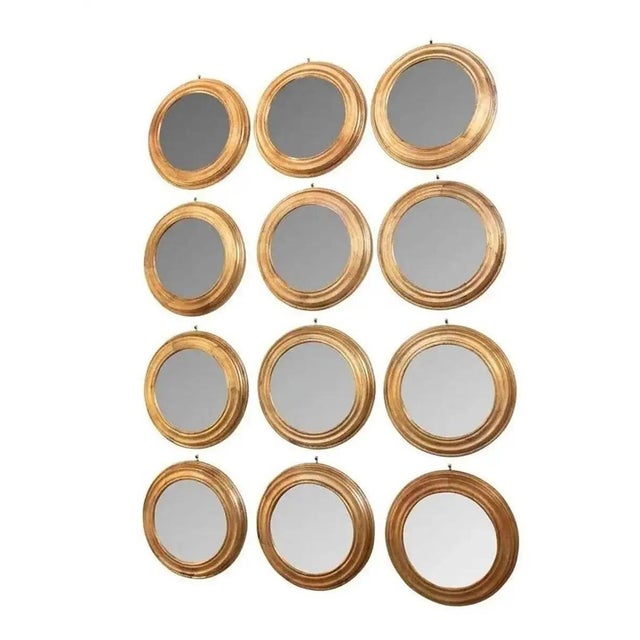 Set of 12 Italian gilt finish round wood mirrors. Each mirror is 11" diameter x 1.25" deep. Hanger on back for hanging....