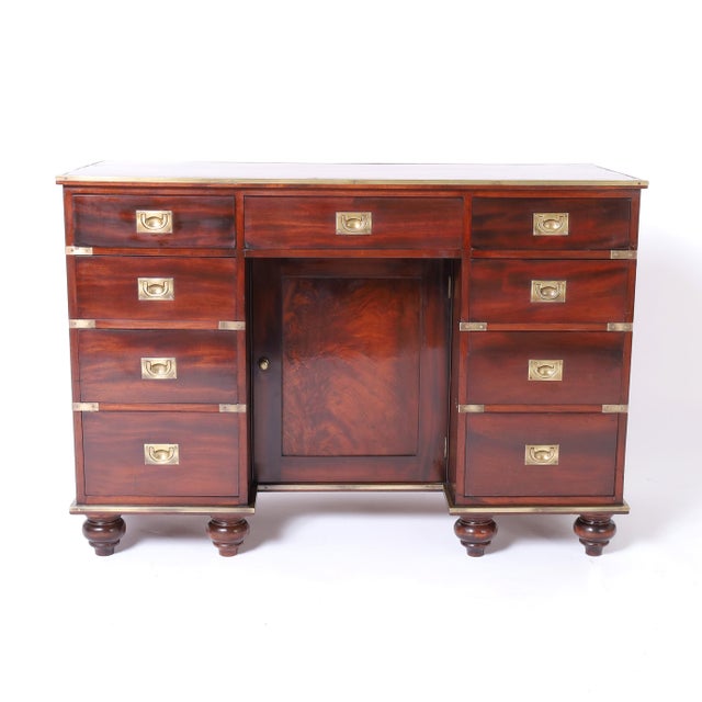Handsome antique British colonial desk Crafted in mahogany in a campaign form with the original red leather top, nine...