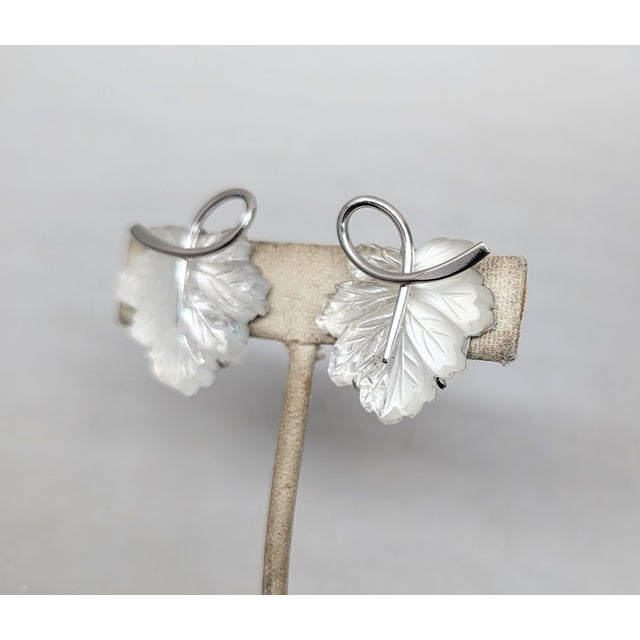 Rare 1950s rhodium plated molded half frosted half clear leaf butterfly clip back earrings. Marked "NAPIER PAT. PEND." on...