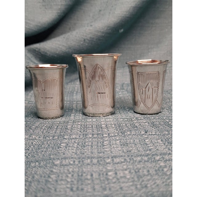 These exquisite antique Russian silver kiddush cups exemplify fine Judaica silverwork from the early 20th century....