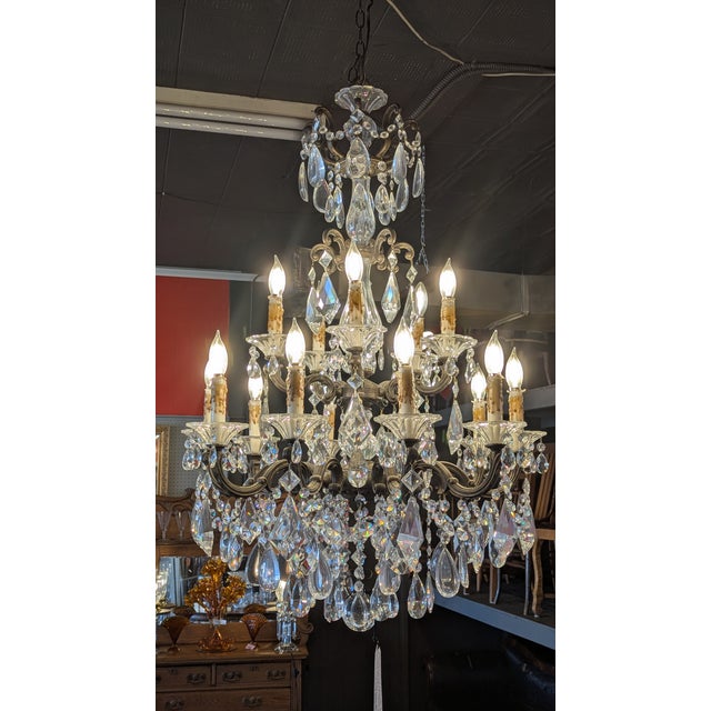 Here is a stunning large metal and crystal chandelier with 15 light arms in two tiers 28" round by 44" high. All original...