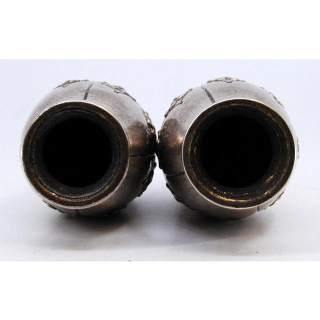 Small Vases in Embossed Silver with Floral Motifs, Set of 2, in Very Good conditions. Designed 1890 to 1919 This piece has...