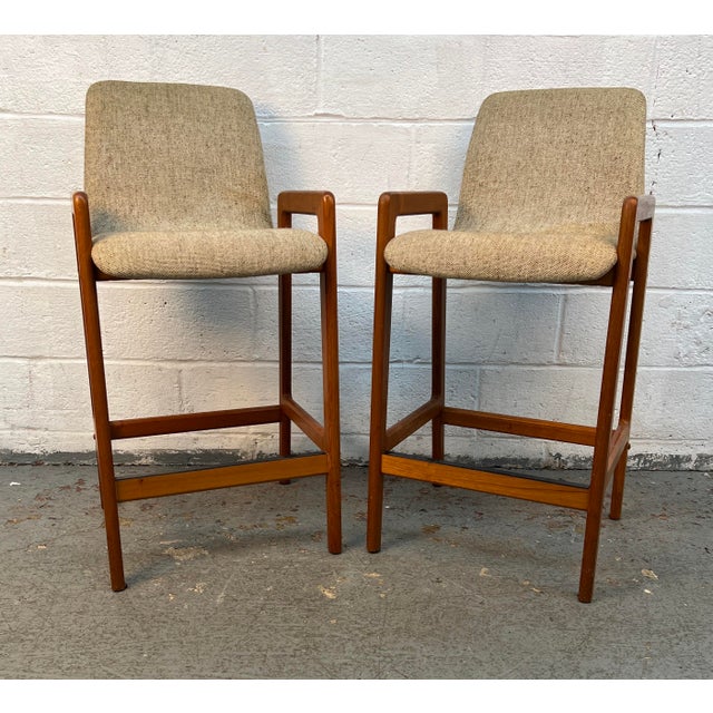 Beautiful pair of mid-century Danish teak tall stools by Tarm Stole for Og Møbelfabrik A/S, showcasing the clean lines,...