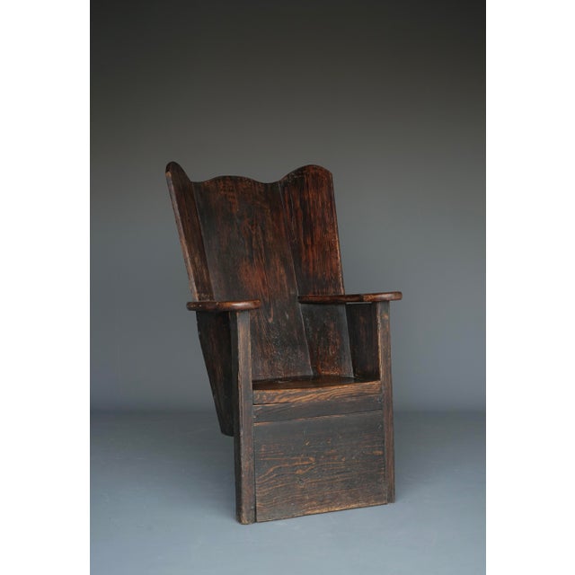 A Welsh antique high back chair known as a lambing chair. It was made around 1820 and historically these chairs were used...