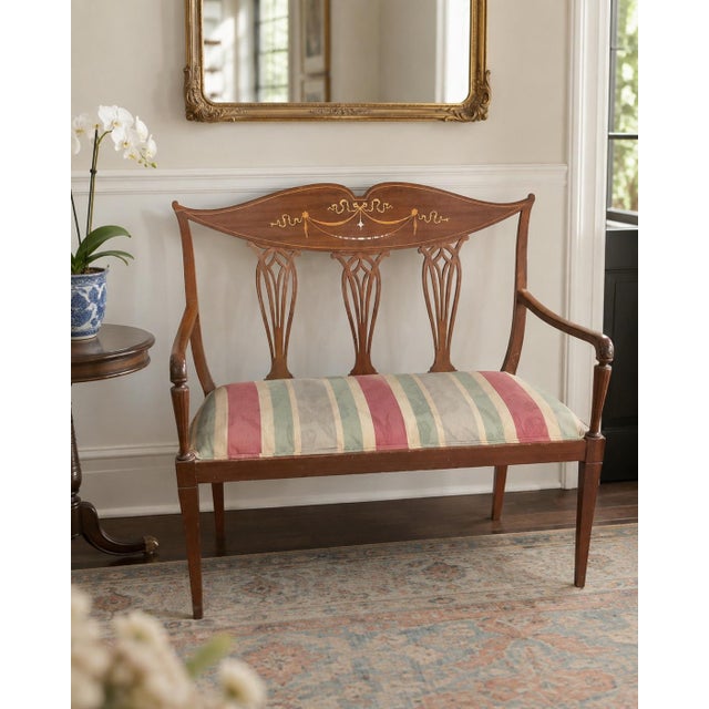 Beautiful antique Edwardian-style settee featuring a wood frame with intricate wood and mother-of-pearl inlay, elegant...