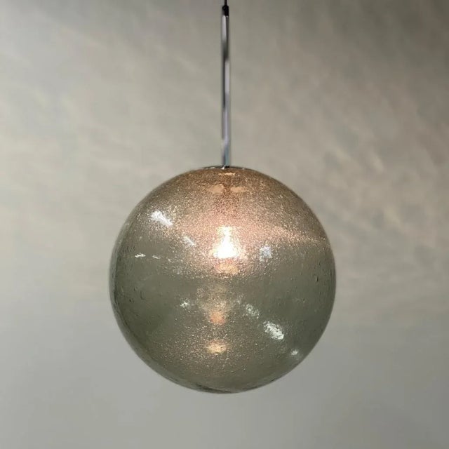 Pair Peill & Putzler pendant from the seventies made of transparent glass with bubbles. These mouth-blown bubble glass...